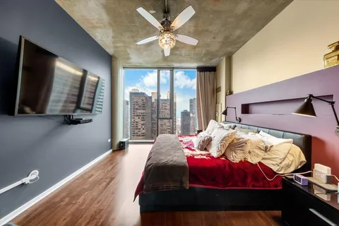 a bedroom with bed and a large window