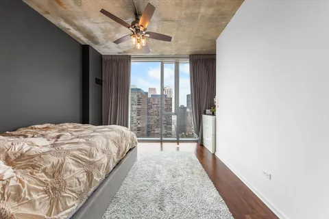 a bedroom with a bed and a large window