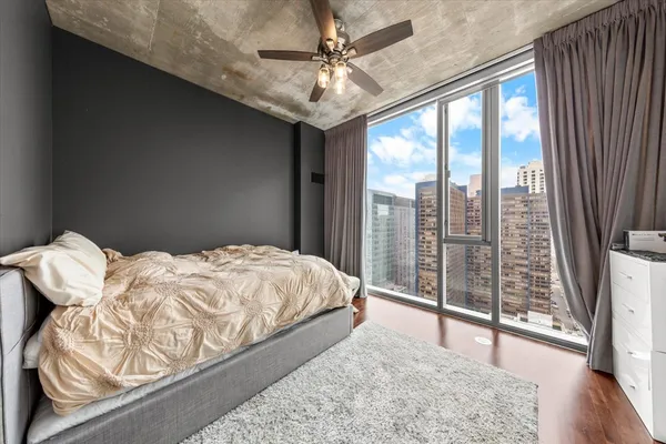 a bedroom with a bed and wooden floor