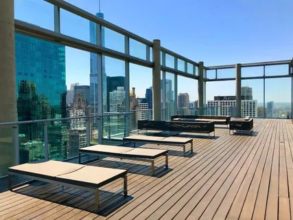 a outdoor sitting area with furniture and wooden floor