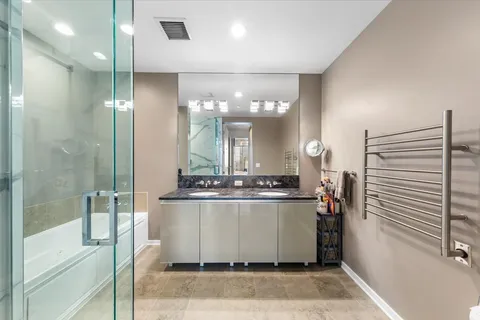 a room with a mirror and a glass door shower