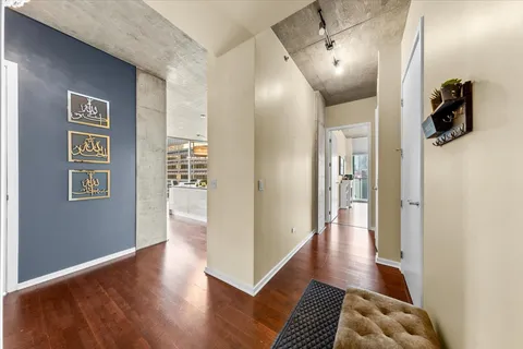 a view of hallway with wooden floor