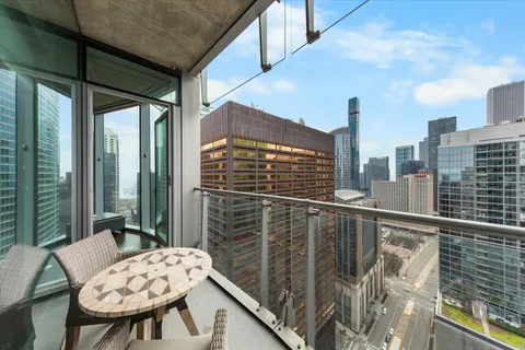 a balcony view with a large window and table in the back