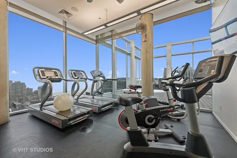 a gym room with furniture and gym equipment