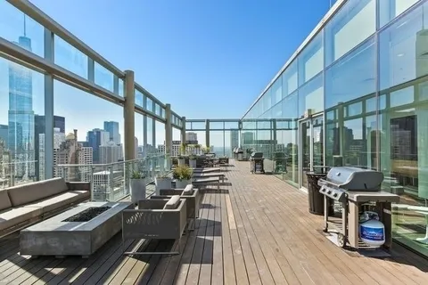 a view of a balcony with couch and wooden floor