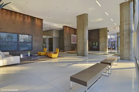 a view of a lobby with a couch and a rug