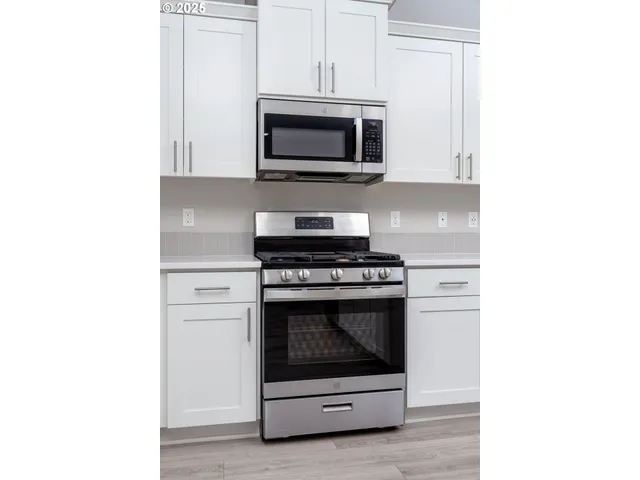 a kitchen with a stove and a microwave