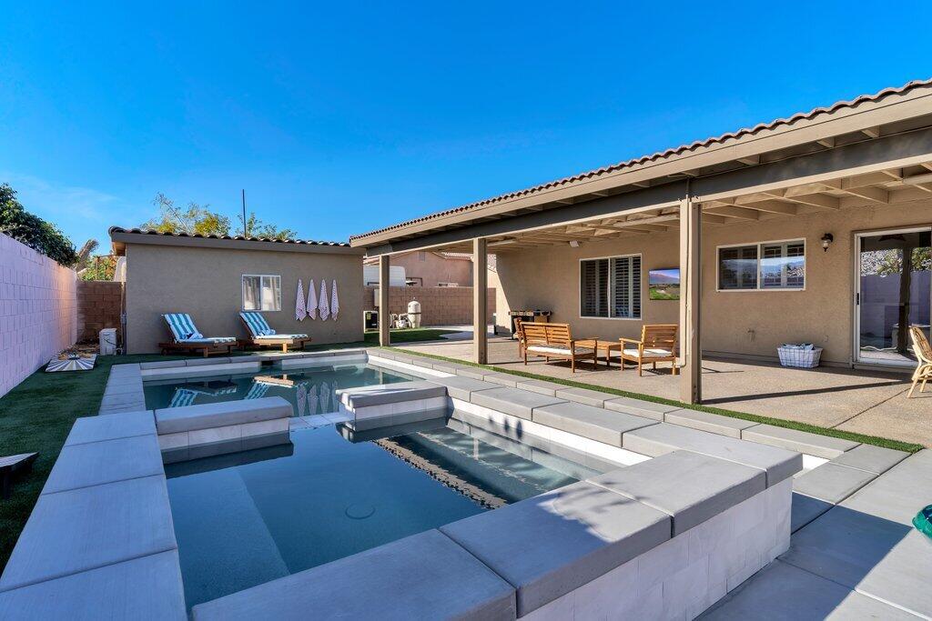 83347 Mango Walk Indio, CA 92201 - Photo 2 of 49 a view of a patio with couches and table with potted plants