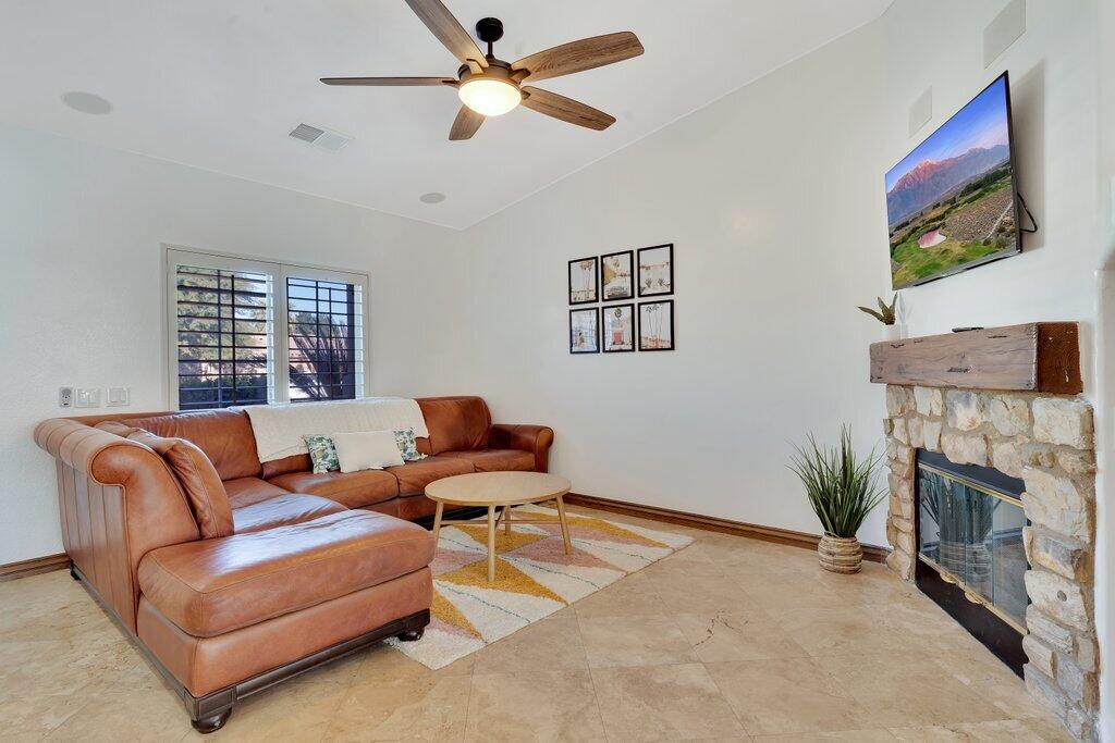 83347 Mango Walk Indio, CA 92201 - Photo 21 of 49 a living room with furniture a fireplace and a flat screen tv