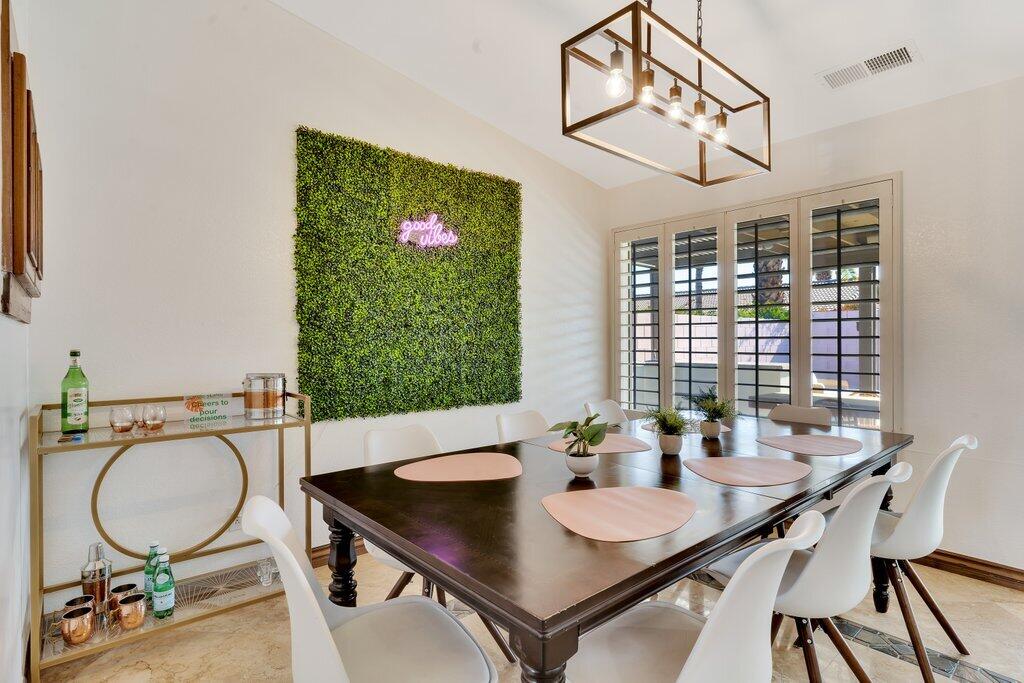 83347 Mango Walk Indio, CA 92201 - Photo 22 of 49 a view of a dining room with furniture window and wooden floor