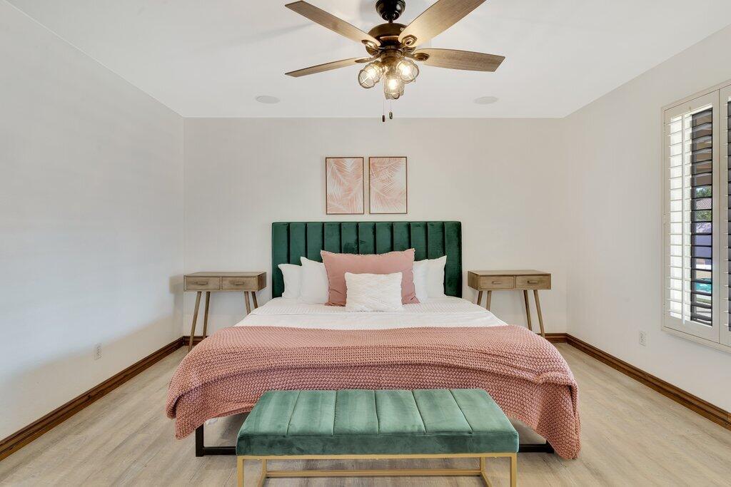 83347 Mango Walk Indio, CA 92201 - Photo 31 of 49 a bedroom with a bed chandelier and a window