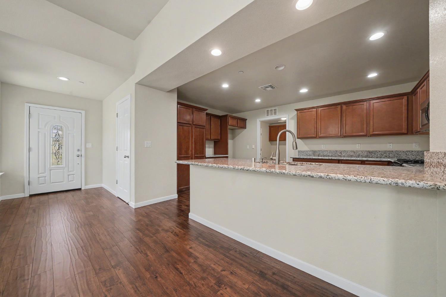 159 Emerald Lane Jackson, CA 95642 - Photo 17 of 58 a view of kitchen with stainless steel appliances granite countertop refrigerator oven a sink and dishwasher with wooden floor