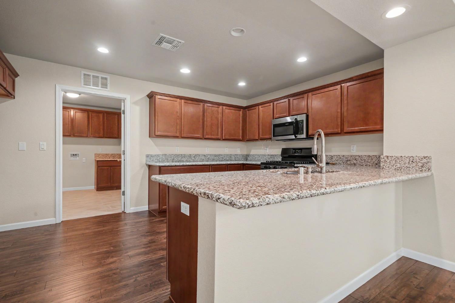 159 Emerald Lane Jackson, CA 95642 - Photo 18 of 58 a kitchen with stainless steel appliances granite countertop a sink stove and refrigerator