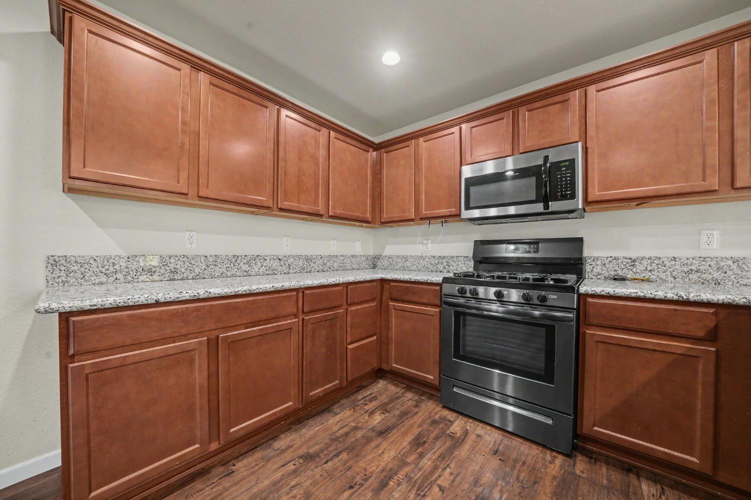 159 Emerald Lane Jackson, CA 95642 - Photo 21 of 58 a kitchen with stainless steel appliances granite countertop a stove microwave and sink