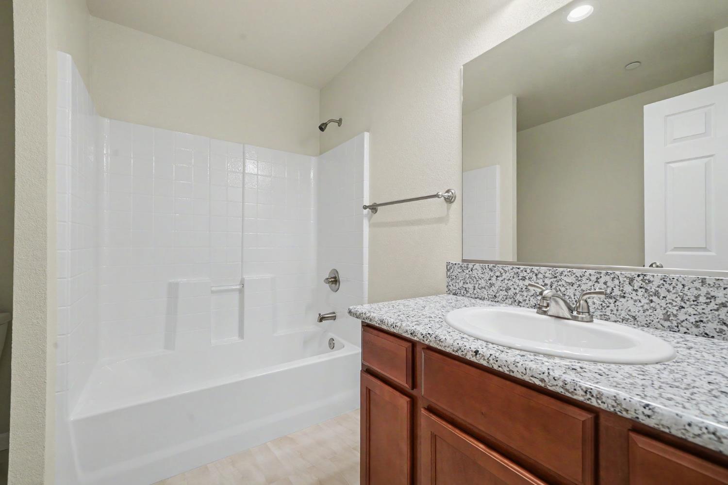 159 Emerald Lane Jackson, CA 95642 - Photo 26 of 58 a bathroom with a granite countertop sink mirror and a bathtub