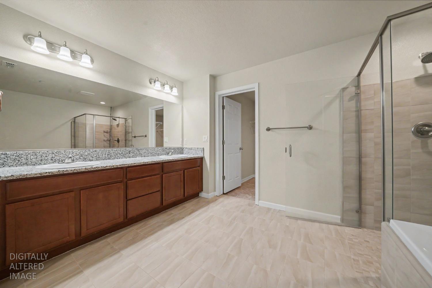 159 Emerald Lane Jackson, CA 95642 - Photo 35 of 58 a spacious bathroom with a granite countertop sink mirror and shower