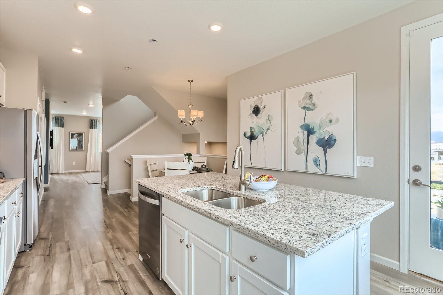 471 Interlocken Boulevard, Unit 101 Broomfield, CO 80021 - Photo 13 of 28 a kitchen with stainless steel appliances granite countertop a sink and refrigerator