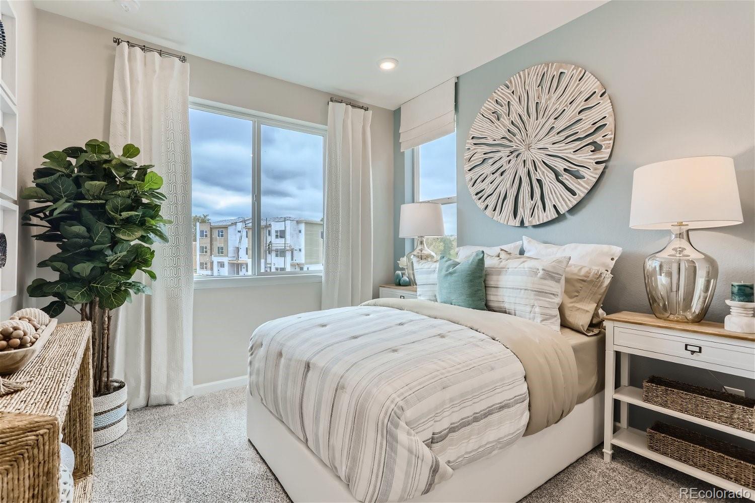 471 Interlocken Boulevard, Unit 101 Broomfield, CO 80021 - Photo 23 of 28 a bedroom with bed and a potted plant