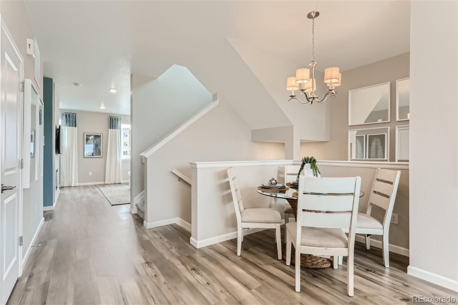 471 Interlocken Boulevard, Unit 101 Broomfield, CO 80021 - Photo 9 of 28 a view of a dining room with furniture wooden floor and chandelier