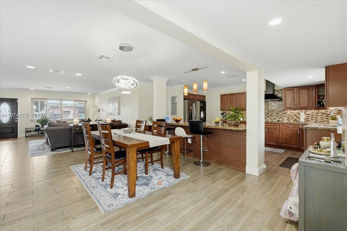 4925 Tyler Street Hollywood, FL 33021 - Photo 16 of 55 a view of a dining hall with furniture and wooden floor