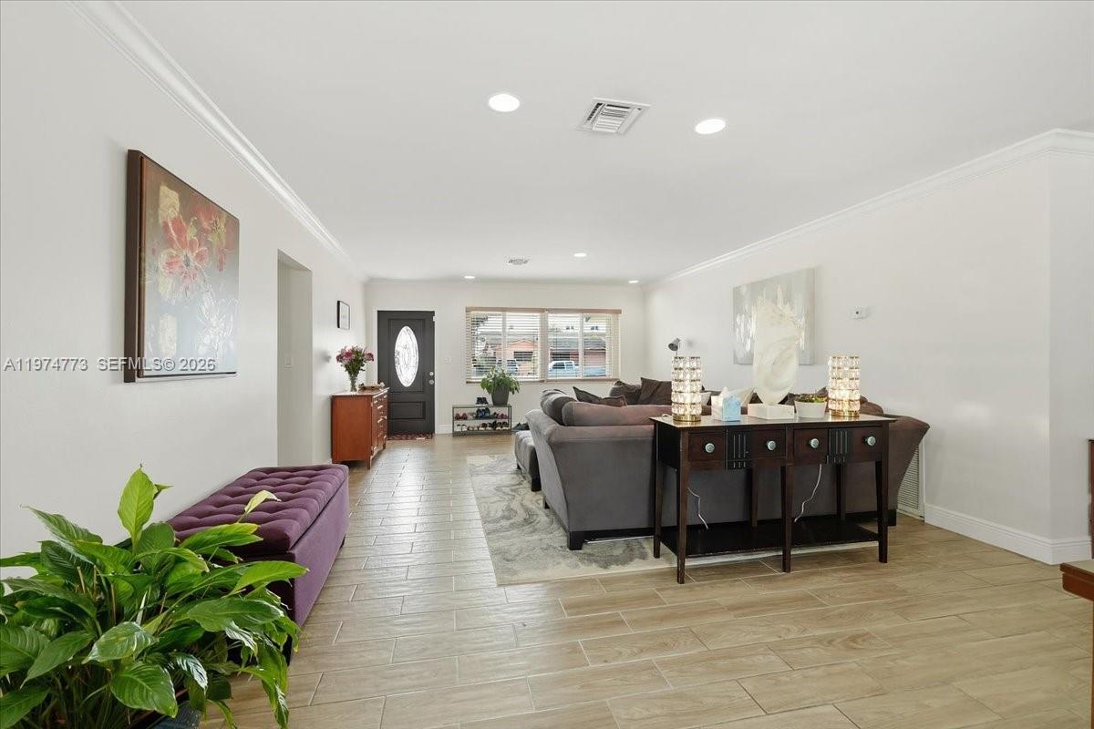 4925 Tyler Street Hollywood, FL 33021 - Photo 20 of 55 a living room with furniture a potted plant and a painting on the wall