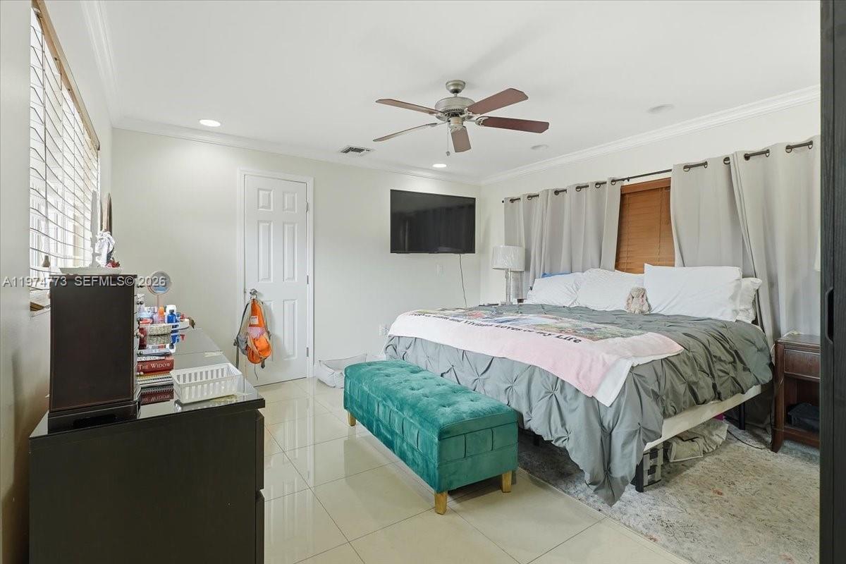 4925 Tyler Street Hollywood, FL 33021 - Photo 23 of 55 a spacious bedroom with a bed and a flat screen tv