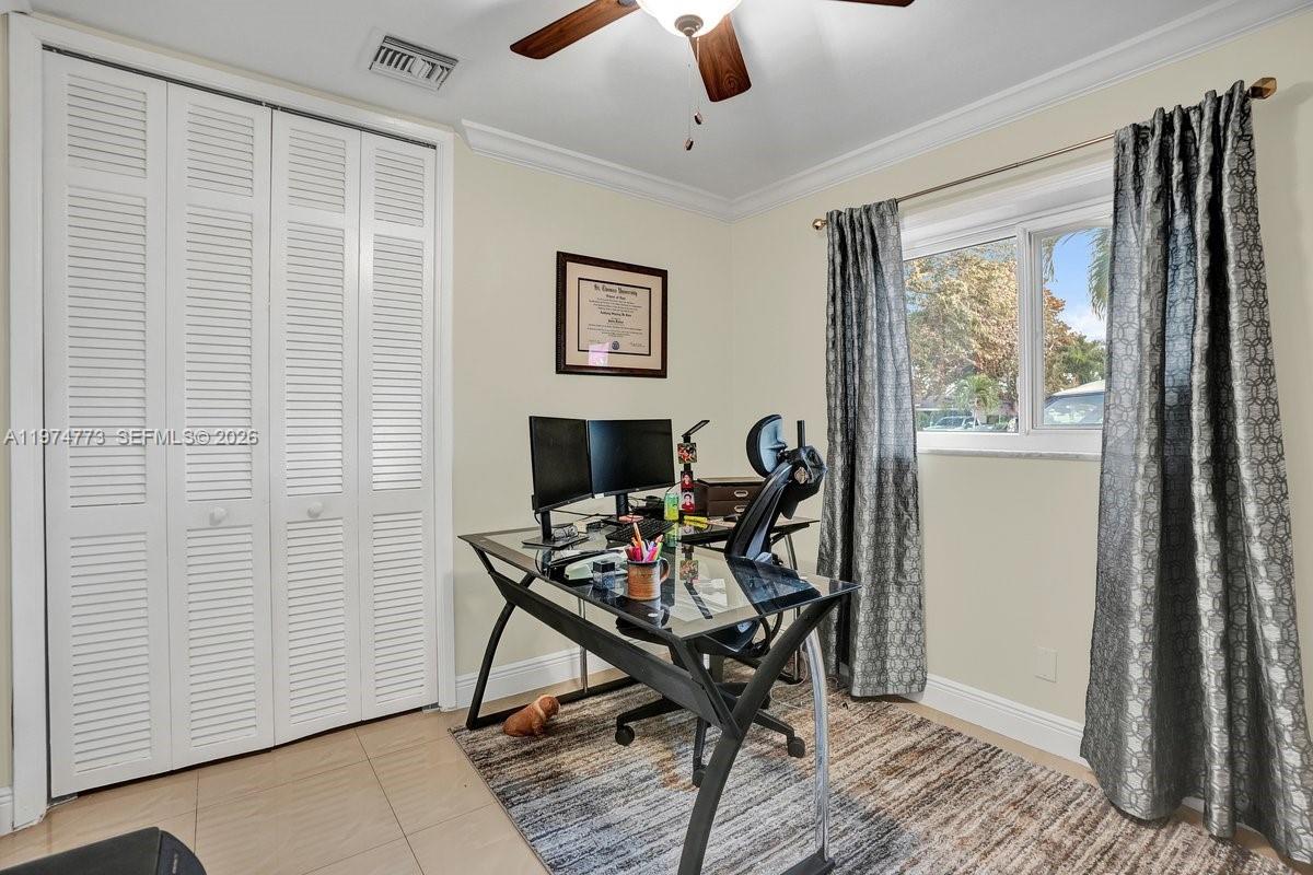 4925 Tyler Street Hollywood, FL 33021 - Photo 35 of 55 a view of a workspace with furniture and a window