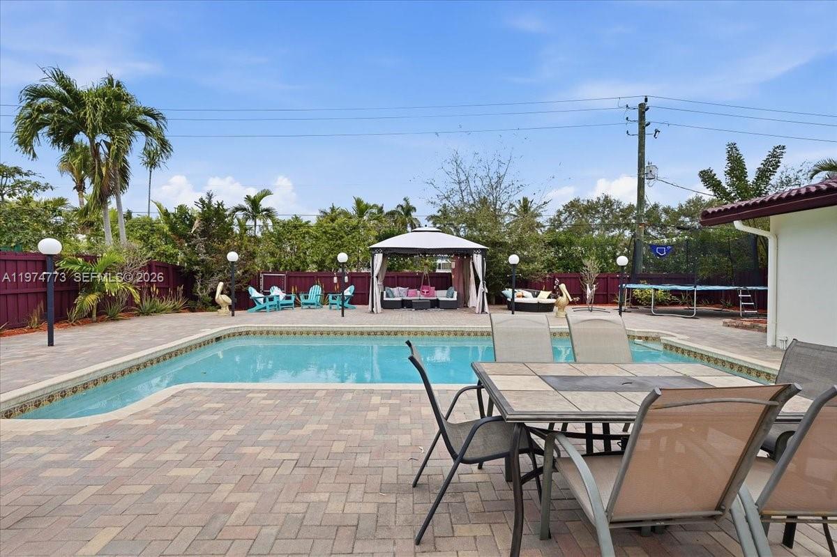 4925 Tyler Street Hollywood, FL 33021 - Photo 38 of 55 a dinning table and chairs in patio of the house