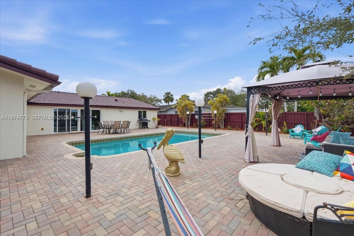 4925 Tyler Street Hollywood, FL 33021 - Photo 44 of 55 a view of a patio with a table and chairs