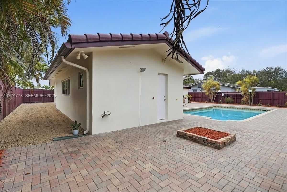 4925 Tyler Street Hollywood, FL 33021 - Photo 47 of 55 a view of a house with a wooden fence