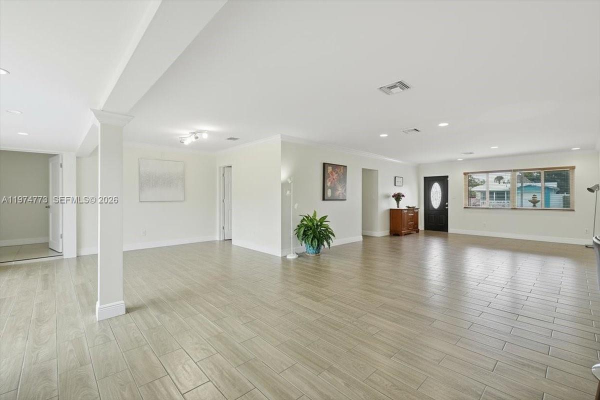 4925 Tyler Street Hollywood, FL 33021 - Photo 48 of 55 a view of an empty room with window and wooden floor