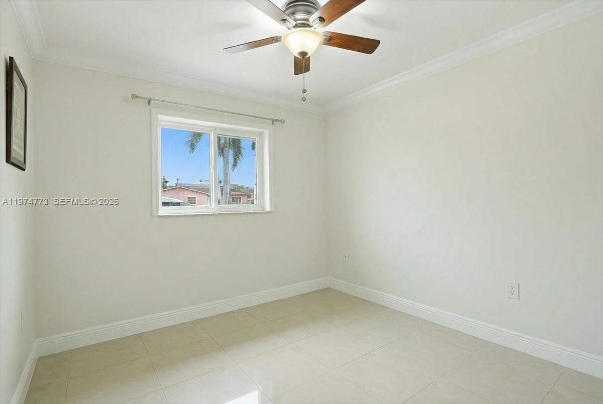 4925 Tyler Street Hollywood, FL 33021 - Photo 50 of 55 an empty room with a window and a fan
