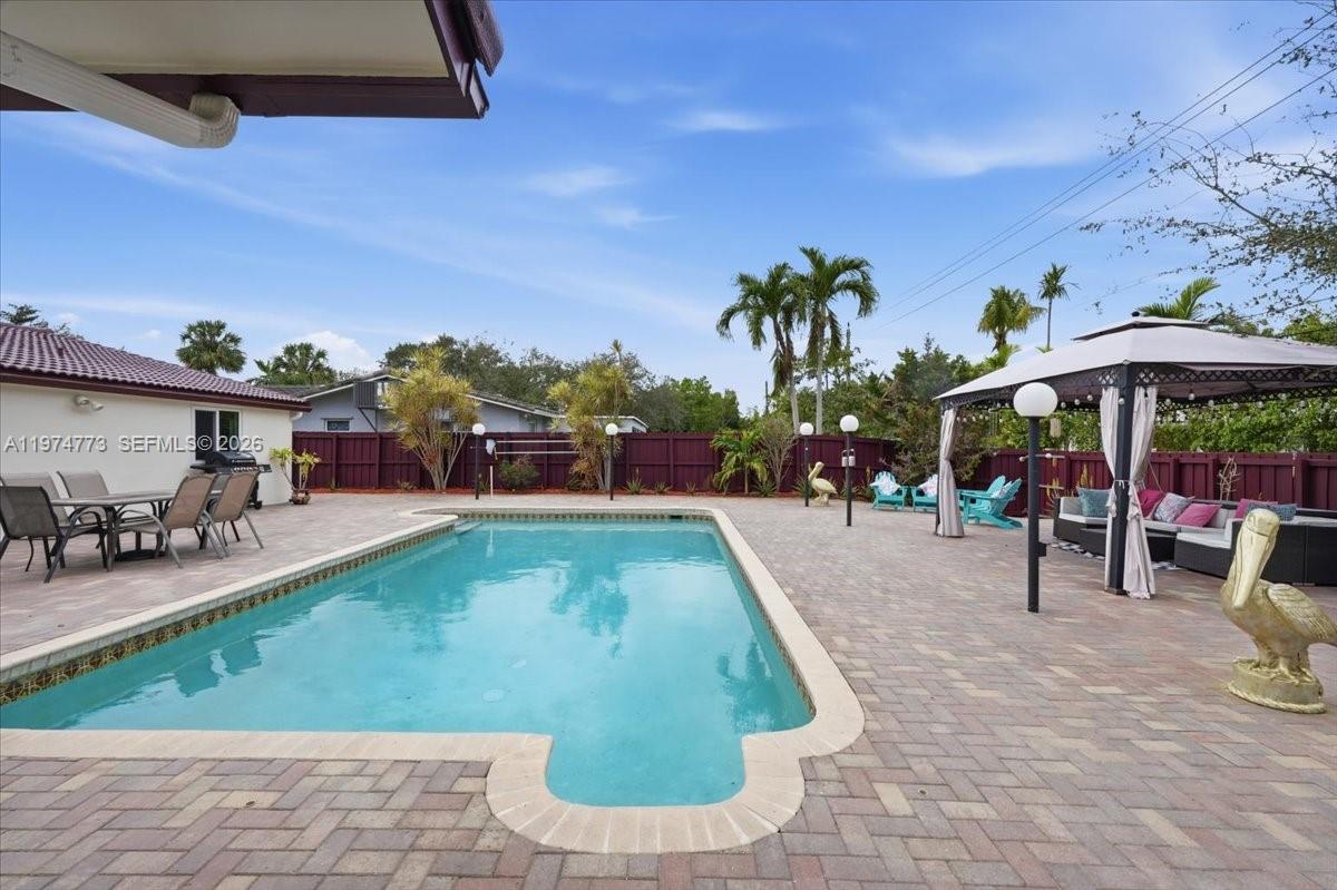 4925 Tyler Street Hollywood, FL 33021 - Photo 5 of 55 a view of a swimming pool with sitting area