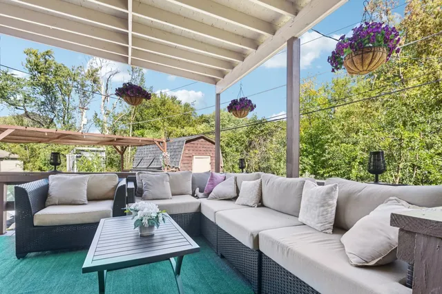 a view of a wooden deck and a backyard