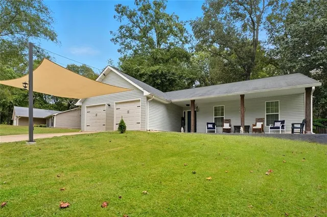a view of a house with swimming pool and porch