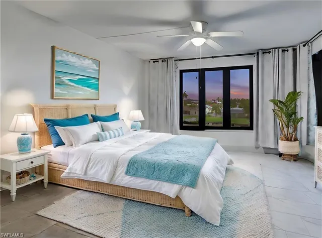 a bedroom with a large bed and a large window