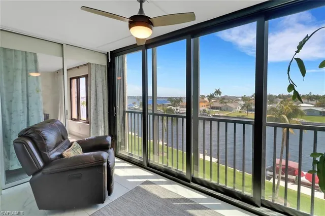 a living room with furniture tv and a window