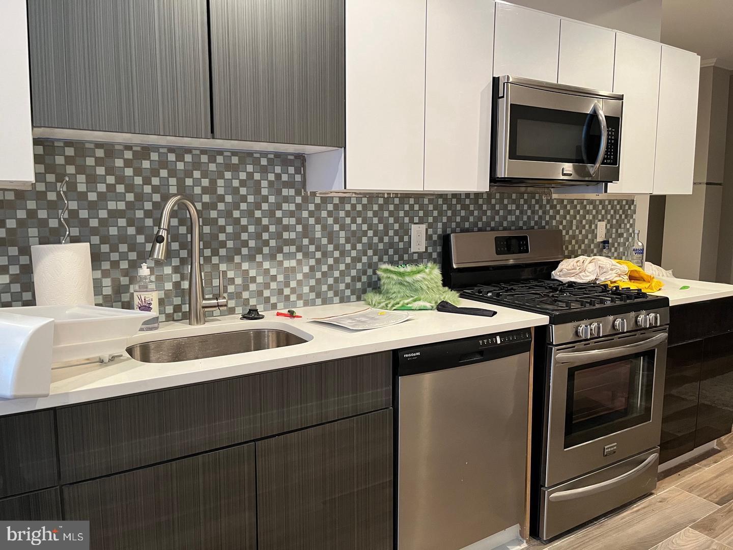 1701 South Street, Unit 1F Philadelphia, PA 19146 - Photo 3 of 11 a kitchen with a sink stove and microwave
