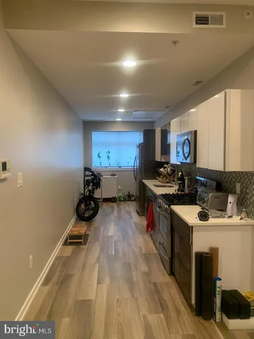 a kitchen with a stove a sink and a refrigerator