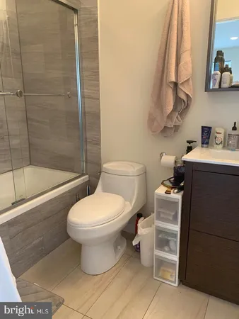 a bathroom with a toilet sink and shower