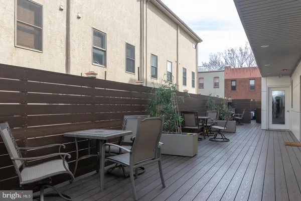 a view of a patio with table and chairs and wooden floor