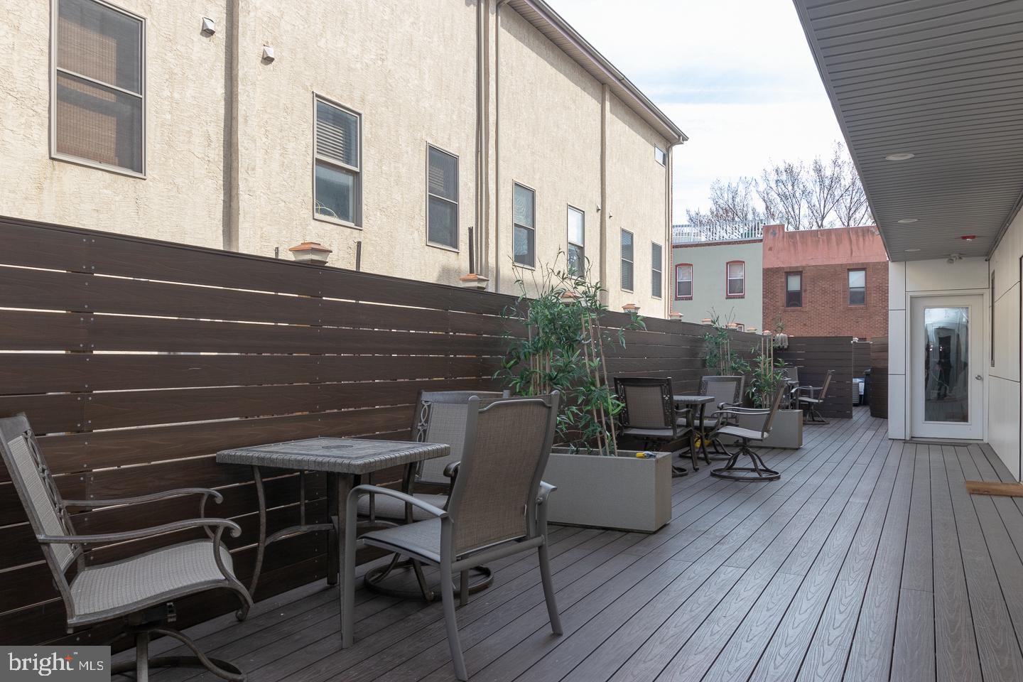 1701 South Street, Unit 1F Philadelphia, PA 19146 - Photo 9 of 11 a view of a patio with table and chairs and wooden floor