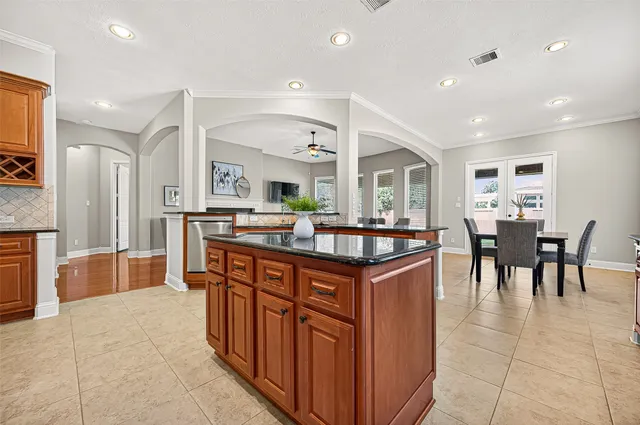 a large kitchen with kitchen island a sink and a large counter space