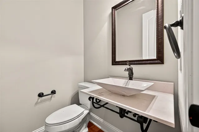 a bathroom with a sink a toilet and mirror