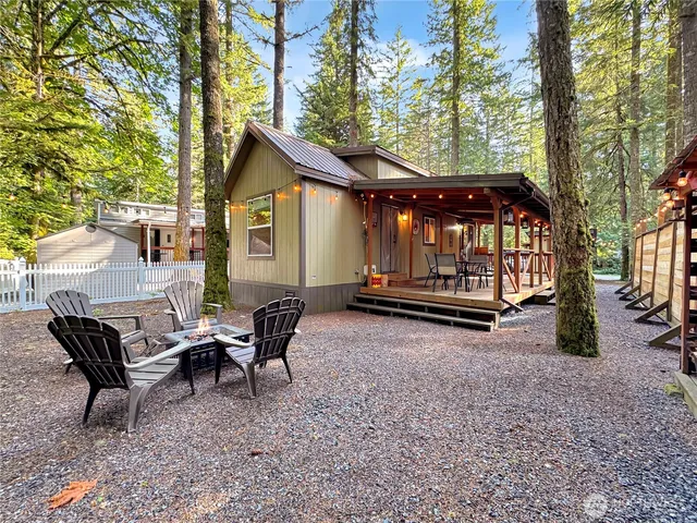 a view of house with backyard and sitting area