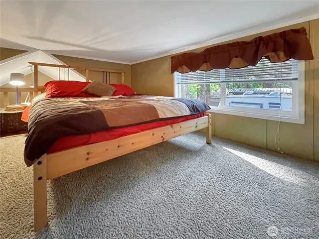 a bedroom with a bed and window