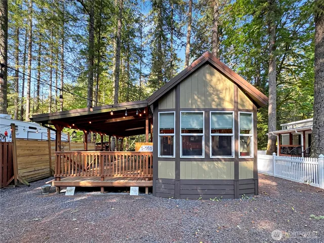 a view of a house with a yard balcony and fence