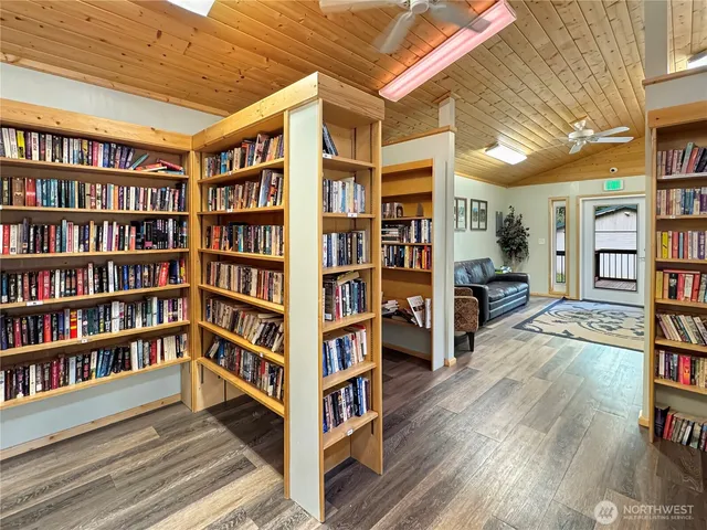 a view of living room and wooden shelves