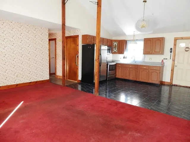 a kitchen with stainless steel appliances granite countertop a refrigerator a sink a stove a microwave and island