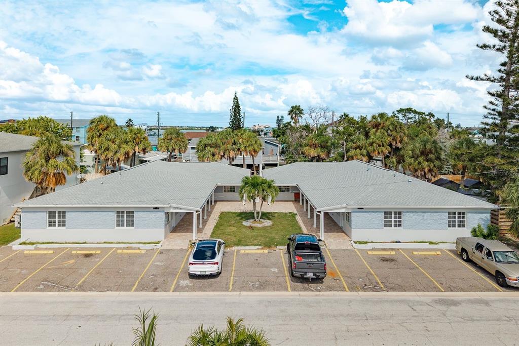 14225 Palm Street, Unit 3 Madeira Beach, FL 33708 - Photo 1 of 1 an aerial view of a house with swimming pool and outdoor seating